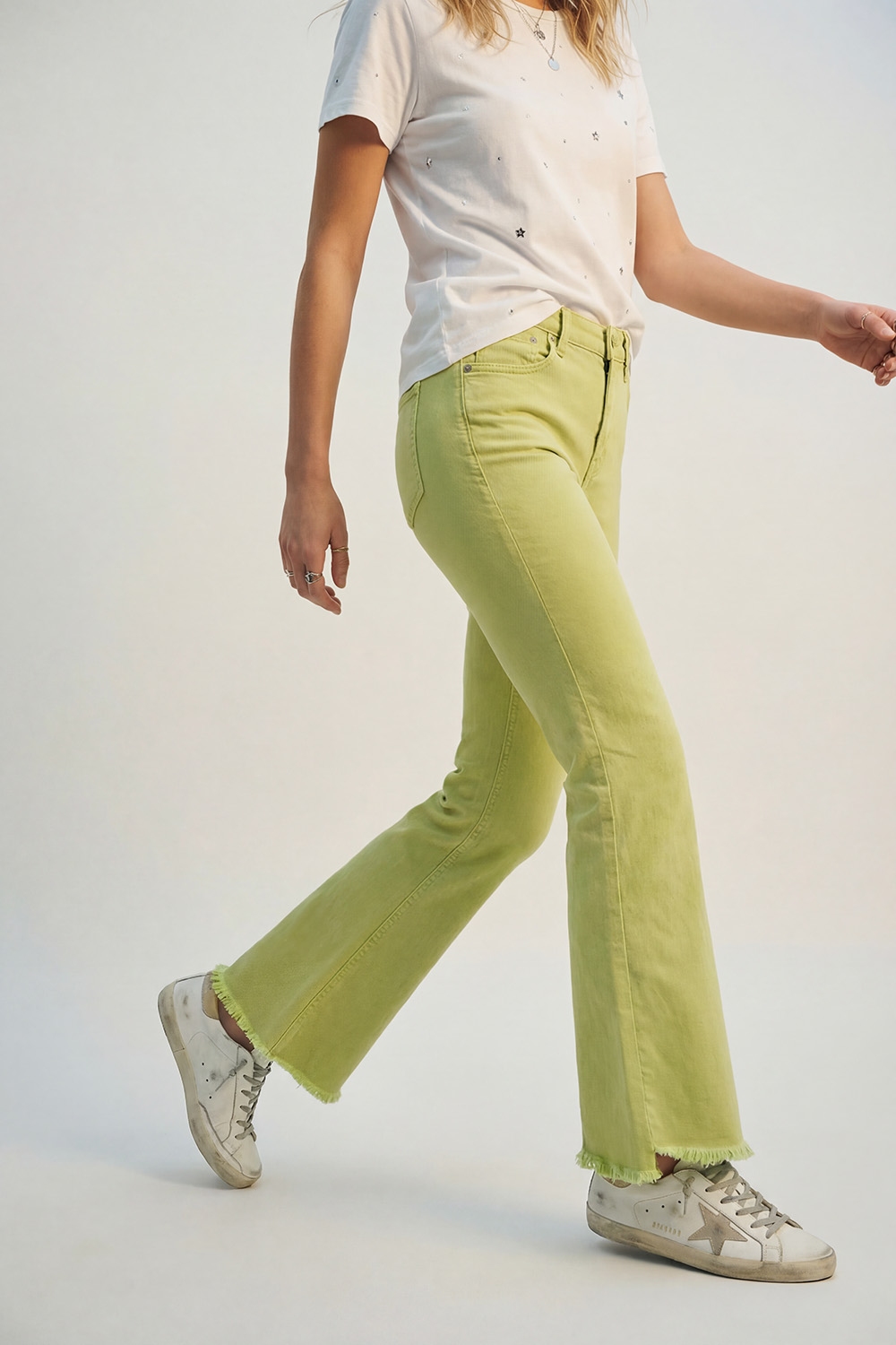 Jeans acampanados con borde sin rematar en color lima Jeans acampanados con borde sin rematar en color lima