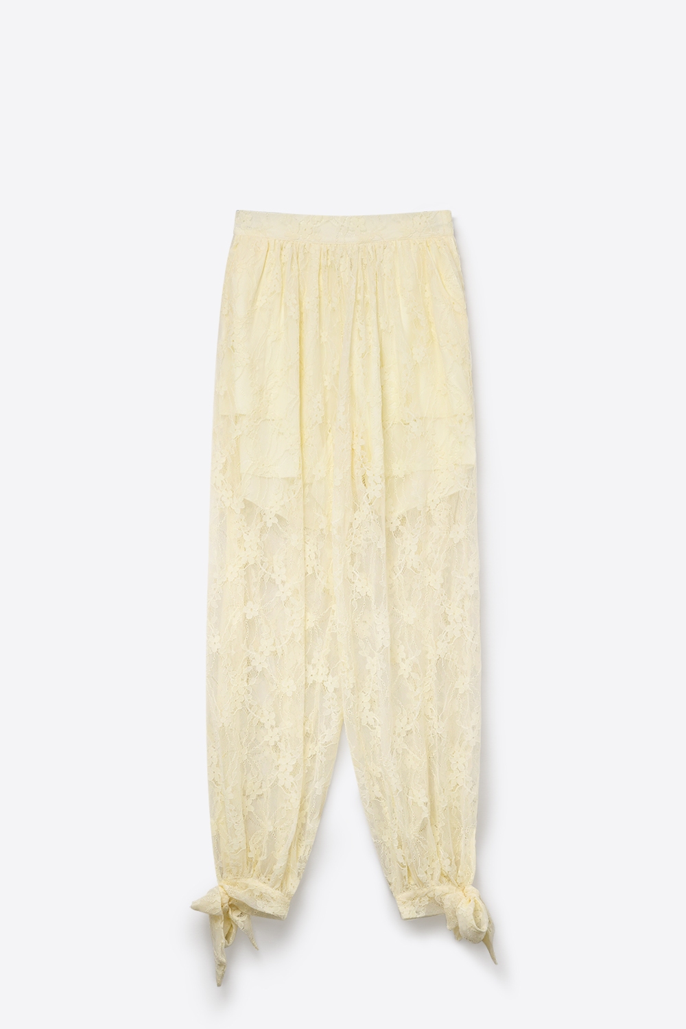 Pantalones de corte relajado con encaje floral color crema y bajo con lazo