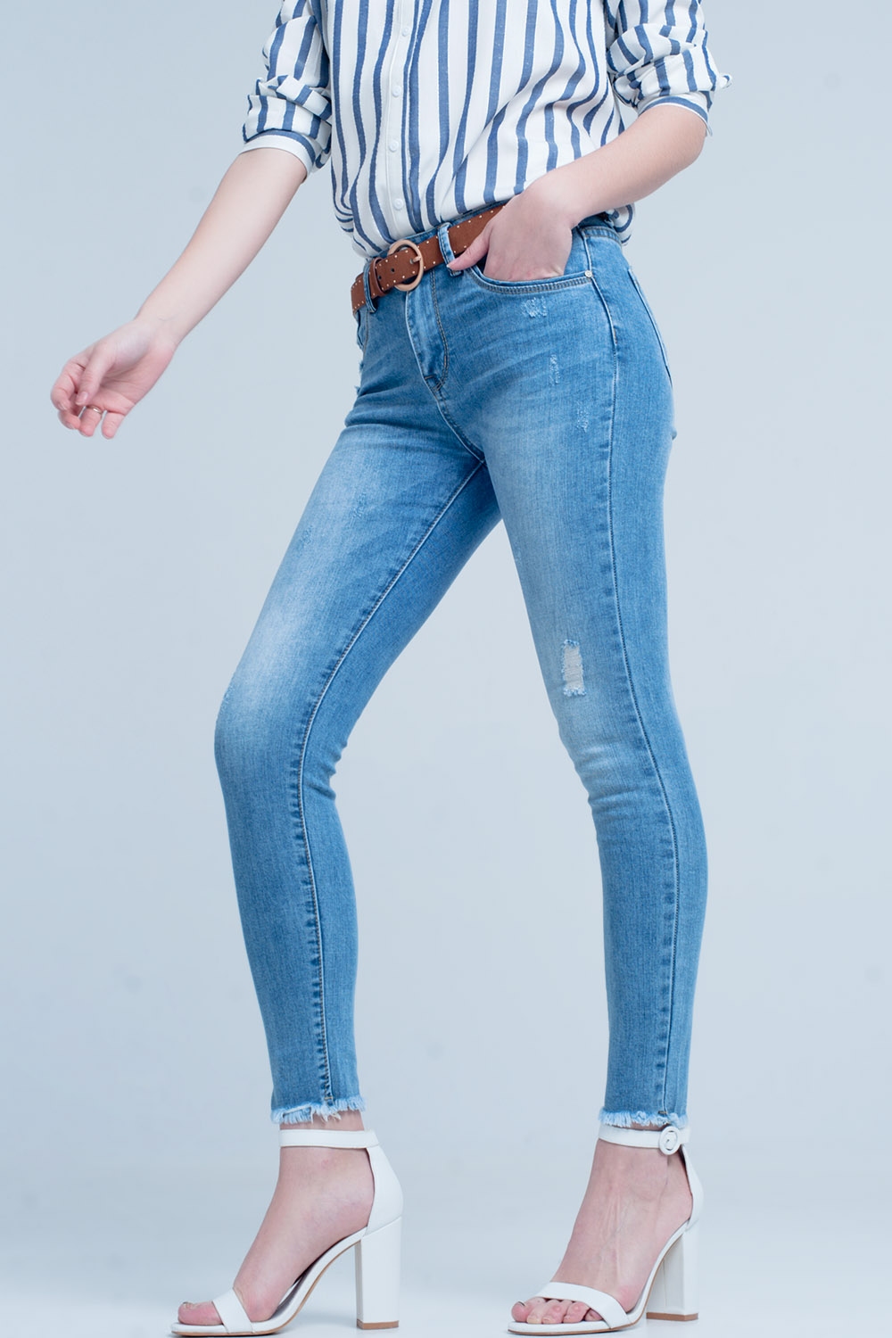 Vaqueros ajustados en azul con detalle rasgado